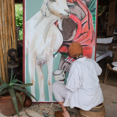 vicki painting a goat