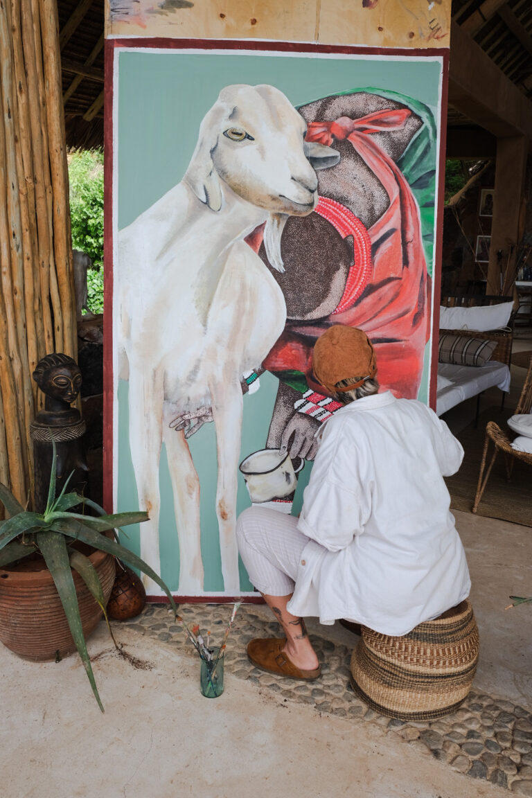 vicki painting a goat